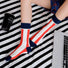 Model wearing a pair of red striped cotton socks, ideal for everyday outfits and sneakers.