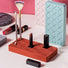 Front view of silicone makeup holder with slots, holding brushes, lipsticks, and jewelry.