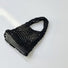 Close-up of Small Multi-Colored Crochet Handbag in black, easy for commuting and weekends.