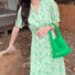 Model carrying a green Crochet handbag handheld, ideal for city walks and gifting.
