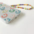 Close-up of Smile Case With Charm. Playful matching decorative flower charm on a flexible body.