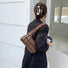 Model wearing a brown PU leather soft puffer shoulder bag with quilted design, easy for commuting and weekends.
