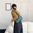 Model carrying a viridian Soft Leather Puffer Bag on the shoulder, ideal for city walks and gifting.