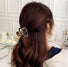 Back view of model with a dark leopard hair claw, strong grip ensures secure and elegant all-day wear.