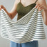 Model holding a striped face towel in hand.