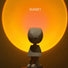 Astronaut lamp projecting a large, warm sunset glow on the wall for a romantic room vibe.