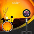 Black iron and aluminum sunset lamp projecting a warm orange glow, with a close-up of its LED lens.