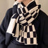 Model wearing a plaid wool scarf in gray, ideal for daily wear and travel.