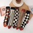 Close-up of five pairs of Thick Retro Socks, easy to pack for travel and errands.