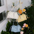 Front view of Three PU leather Mini Cloud Bags in cream, yellow, and blue.