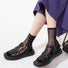 Model wearing a pair of Abstract Pattern Crystal Socks with black dots, great for casual wear and light workouts.