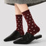 Model wearing a pair of Ancora Red Polka Dot Socks, easy to pack for travel and errands.