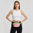 Close-up of a pink AOIO belt bag worn as a front waist bag.