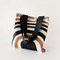 Front view of Arc Line Knitted Bag: Polyester fabric tote with black, white, and brown curved stripes.