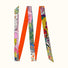 Orange polyester skinny scarf with vibrant artistic print, featuring diverse patterns and colors.