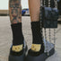 Black smiley knitted socks made of soft cotton blend yarn, cozy for daily wear.