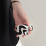 Model Hands holding a black  wave airpods case, ideal for gifting and everyday carry.