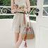 Model carrying the natural straw bucket bag on a sunny day.