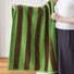 Model holding a Striped Bath Towel in Green-brown, showcasing the detail.