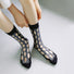 Model wearing a pair of  Bold Hollow Socks in black, ideal for workouts and commuting.