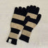 Bold stripe knit gloves in black and khaki with ribbed cuffs; warm accessory for winter commuting.