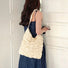 Model carrying a white polyester bag on the shoulder, great for daily carry and travel.