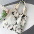 Cream canvas tote bag with black butterfly and floral embroidery, open top, shoulder strap.