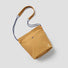 A warm camel casual bag made of durable polyester, offering a pop of color for urban outfits.