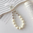 Close-up of Candy Bead Phone Charm in white, easy to attach to bags and phones.
