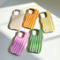 Scattered arrangement of all five candy-striped wavy cases showing different angles and colors.