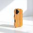 Vertical side-angle view of the orange and white striped wavy phone case.