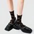 Close-up of Caramel Diamond Socks in black socks, easy to pack for travel and errands.