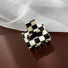 Angled view of checkerboard hair claw in cube shape, ideal for quick updos and ponytails.