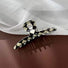 Close-up of checkerboard hair claw in line shape , ideal for quick updos and ponytails.