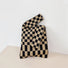Black and coffee checkered woven tote bag showing its minimalist aesthetic.