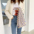 Model styling the purple and yellow checkered woven tote bag with a casual outfit.
