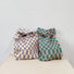 Display of the two checkered woven tote bag in pink-green and purple-yellow, showing the soft-touch texture.