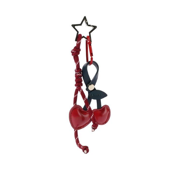 Red PU leather cherry bag charm with a star keyring and dark blue strap.