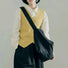 Model carrying a  Chic Day Hobo Bag in black, easy for commuting and weekends.