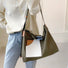 Close-up of green canvas tote featuring secure magnetic closure showcasing practical and modern tech-friendly design.