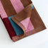 Detail view of Color Game Plaid Face Towel in  Pink-Blue, showcasing cotton fabric and colorful plaid pattern.