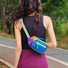 Model wearing the blue color-pop belt bag as a crossbody pack across the back.