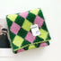 Angled view of Wool-acrylic colorblock diamond scarf in vibrant pink, lime green, and dark green, easy for travel.