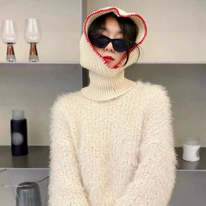 Person wearing a white textured sweater and a hood with red trim Balaclava Hat.