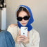 Model wearing Klein blue balaclava hat with playful contrast edges, knitted from soft cotton-acrylic.