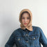Model wearing khaki balaclava hat with multi-tone patterns, highlighting high-quality craftsmanship.