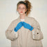 Close-up colored-thread hemming knit gloves with contrast stitching along fingers; cozy for cold days.
