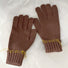 Brown colored-thread hemming gloves with contrast stitched seams; warm knit accessory for outdoors.