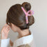 Model wearing  Colored Yarn Hair Claw  in pink, easy for workdays and special occasions.