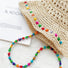 Close-up view of the intricate straw weave and the vibrant bead detailing.